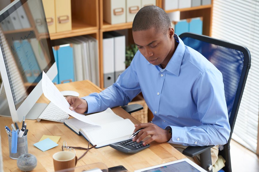 Male Accountant Checking Financial document